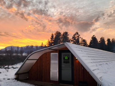 greenhouse in the winter under a beautiful orange sunset