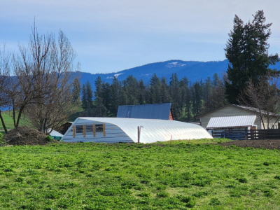 the greenhouse in the snow against the landscape